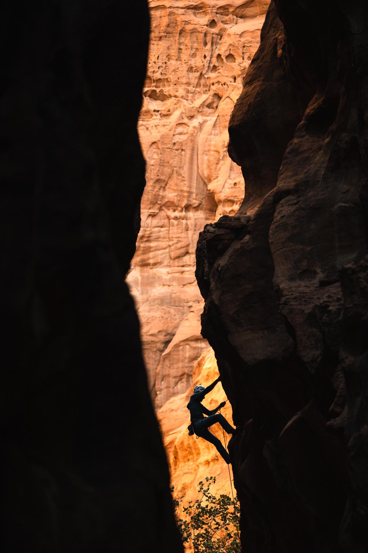 Illustration of a person climbing a mountain, representing the concept of maintaining growth mindset in challenging times.